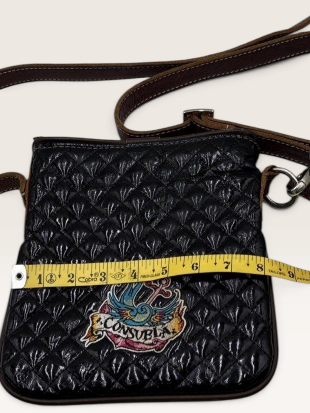 Consuela Black Quilted Crossbody Bag with Embroidered Logo & Tassel
