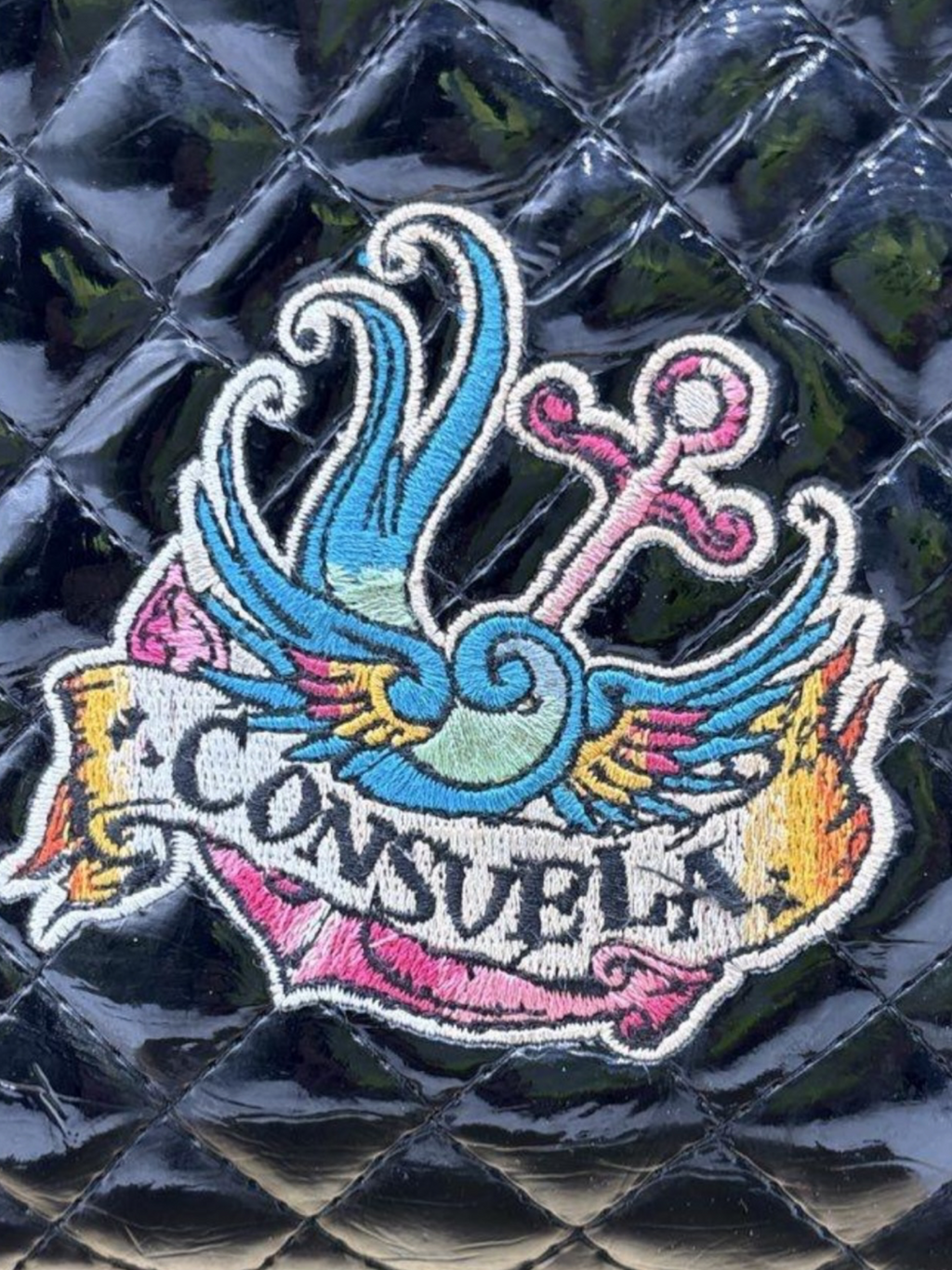 Consuela Black Quilted Crossbody Bag with Embroidered Logo & Tassel