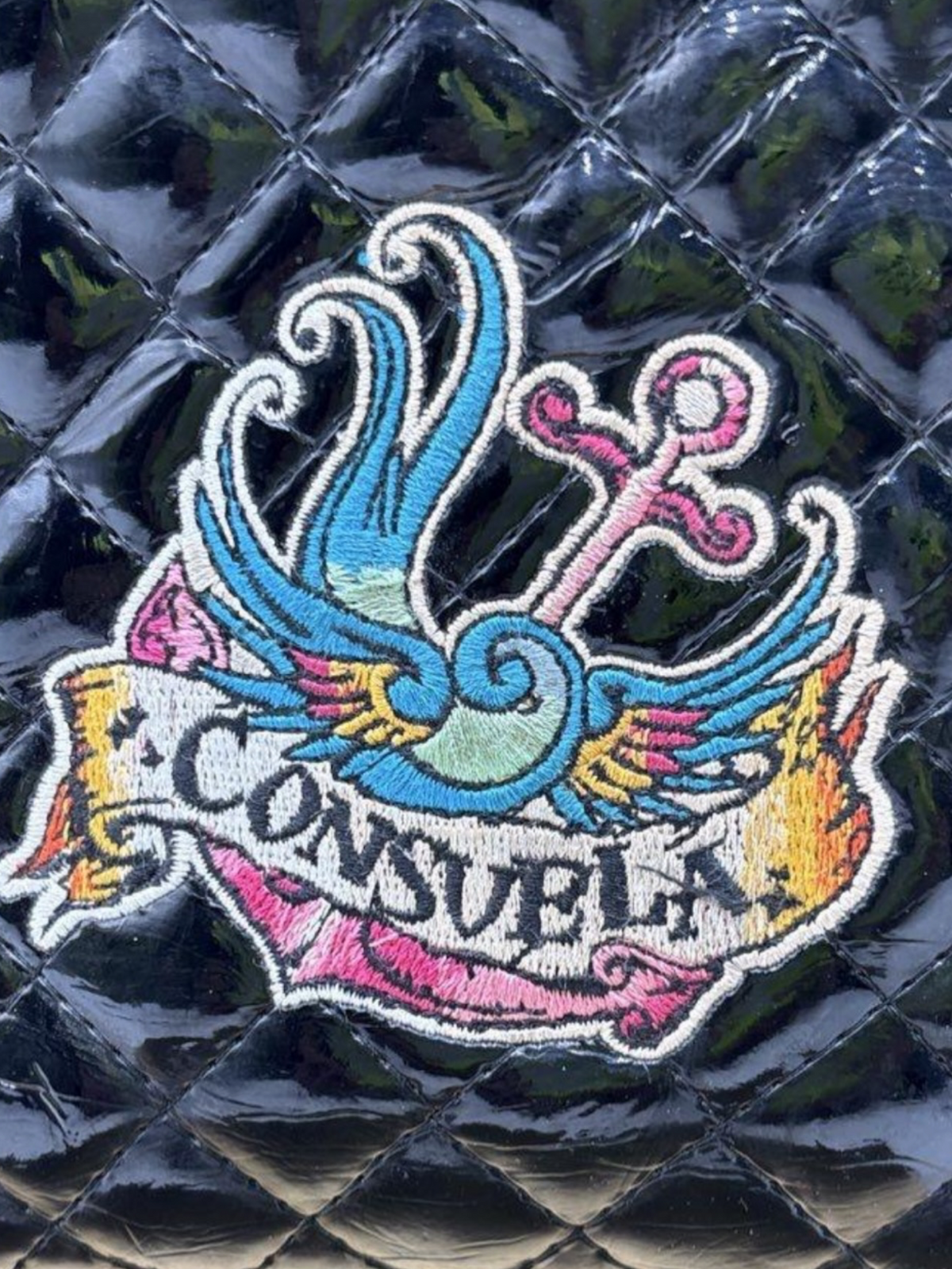 Consuela Black Quilted Crossbody Bag with Embroidered Logo & Tassel