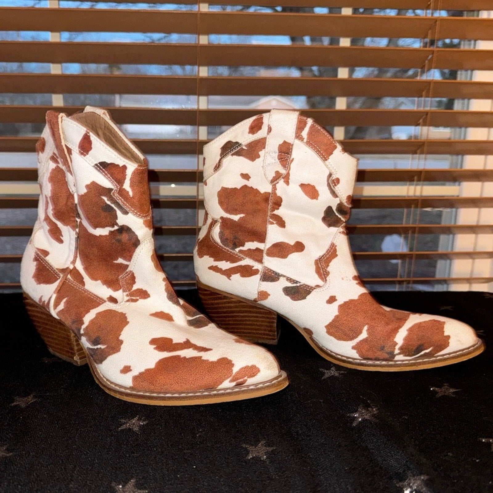 Stylish Dakota Cow Print Ankle Booties by Buckle